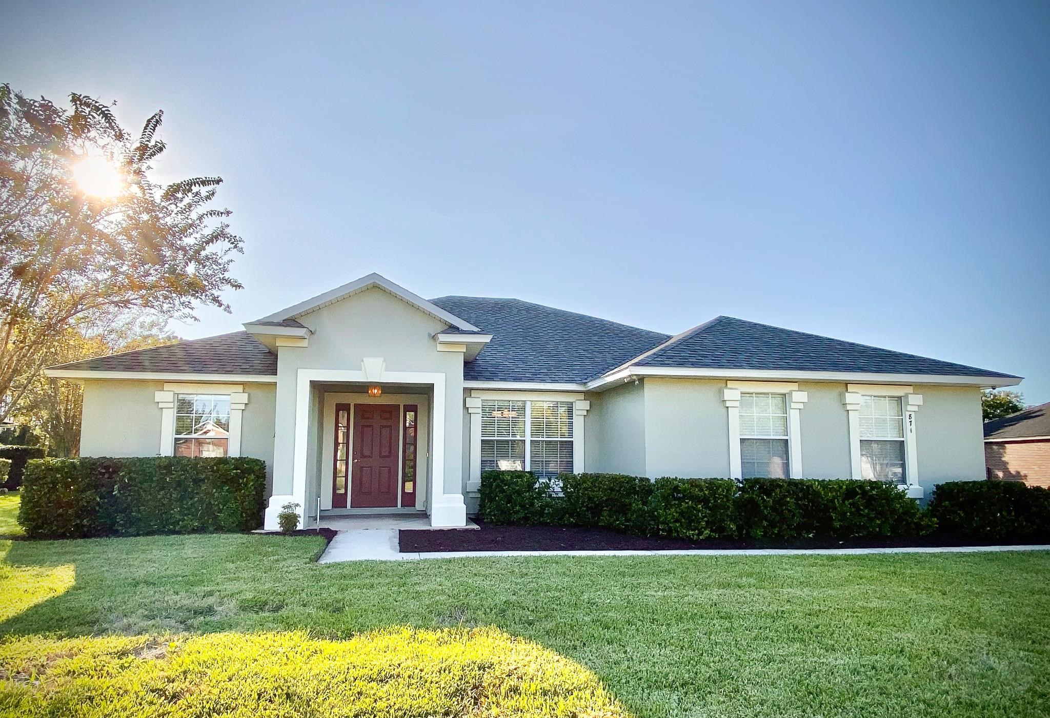 871 East Red House Branch Road St. Augustine, FL 32084 - Photo 1 of 23 a front view of a house with a yard and garage