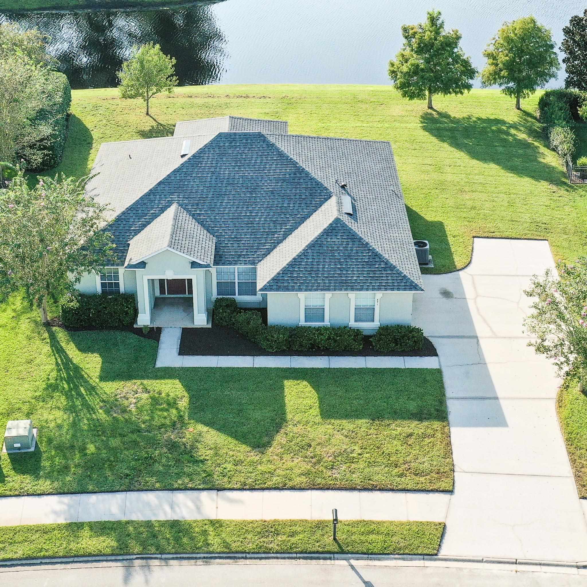 871 East Red House Branch Road St. Augustine, FL 32084 - Photo 2 of 23 a view of house with garden space and lake view