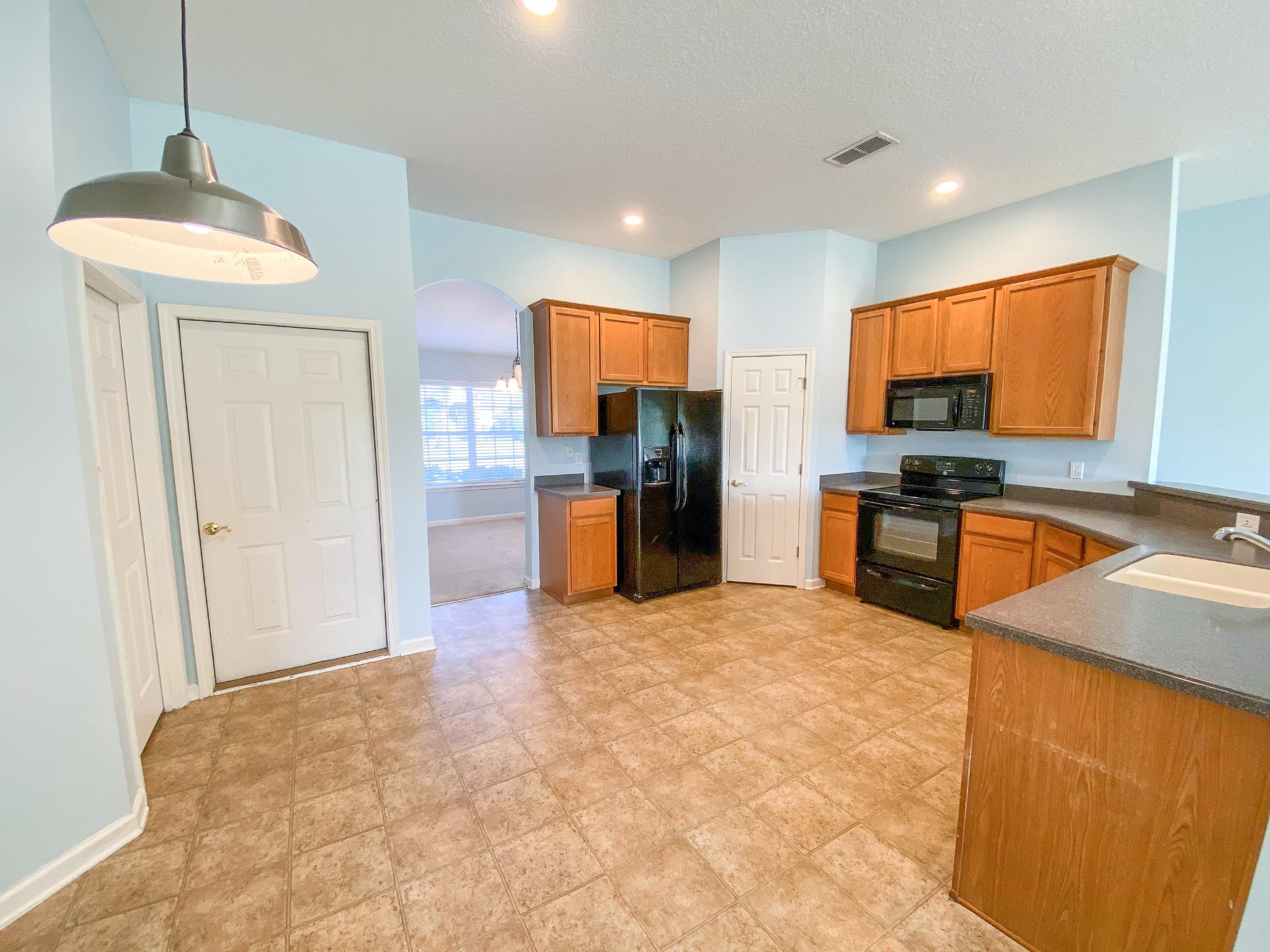 871 East Red House Branch Road St. Augustine, FL 32084 - Photo 13 of 23 a view of kitchen with stainless steel appliances granite countertop cabinets and wooden floor