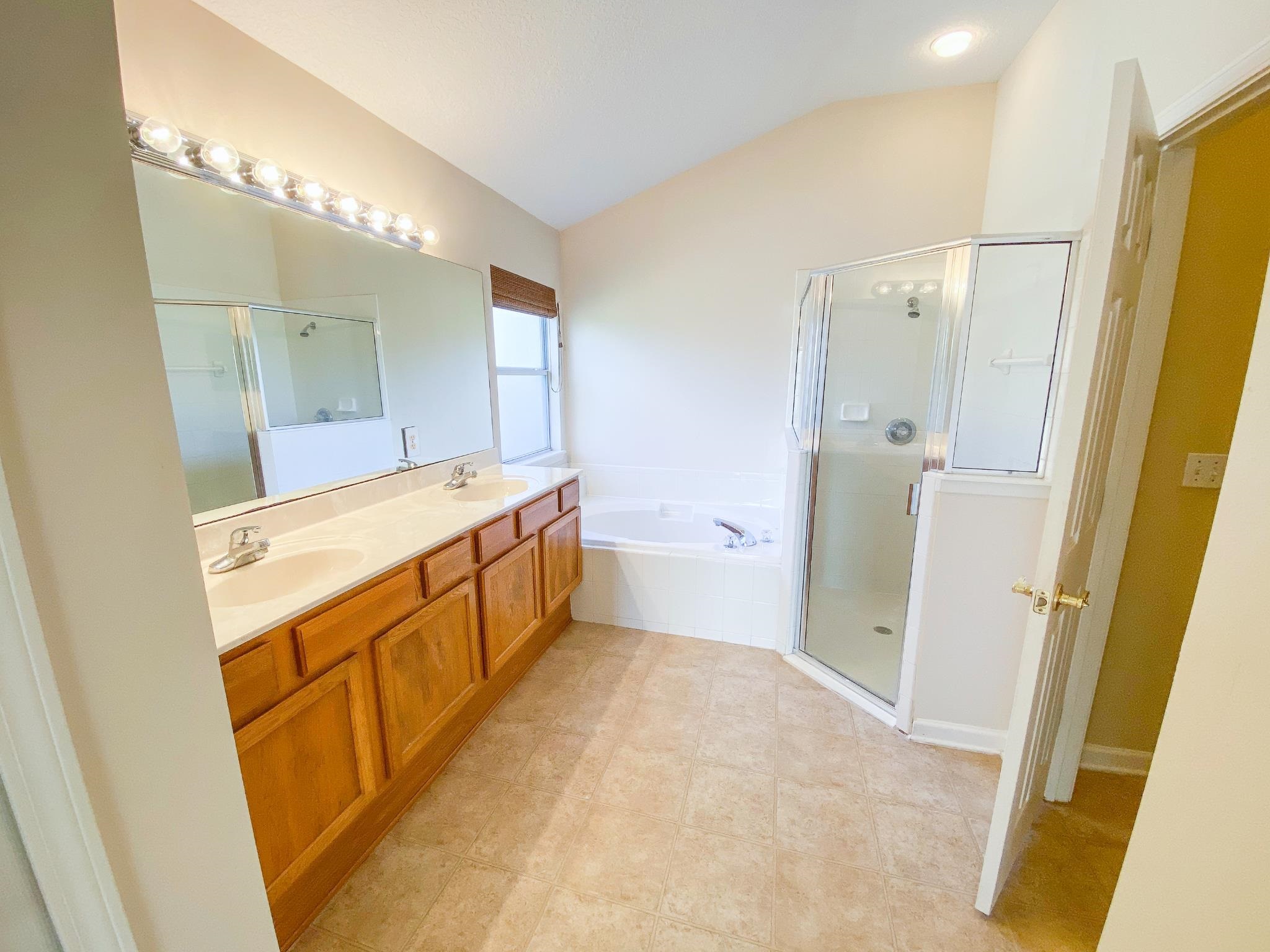 871 East Red House Branch Road St. Augustine, FL 32084 - Photo 16 of 23 a bathroom with a tub sink and mirror