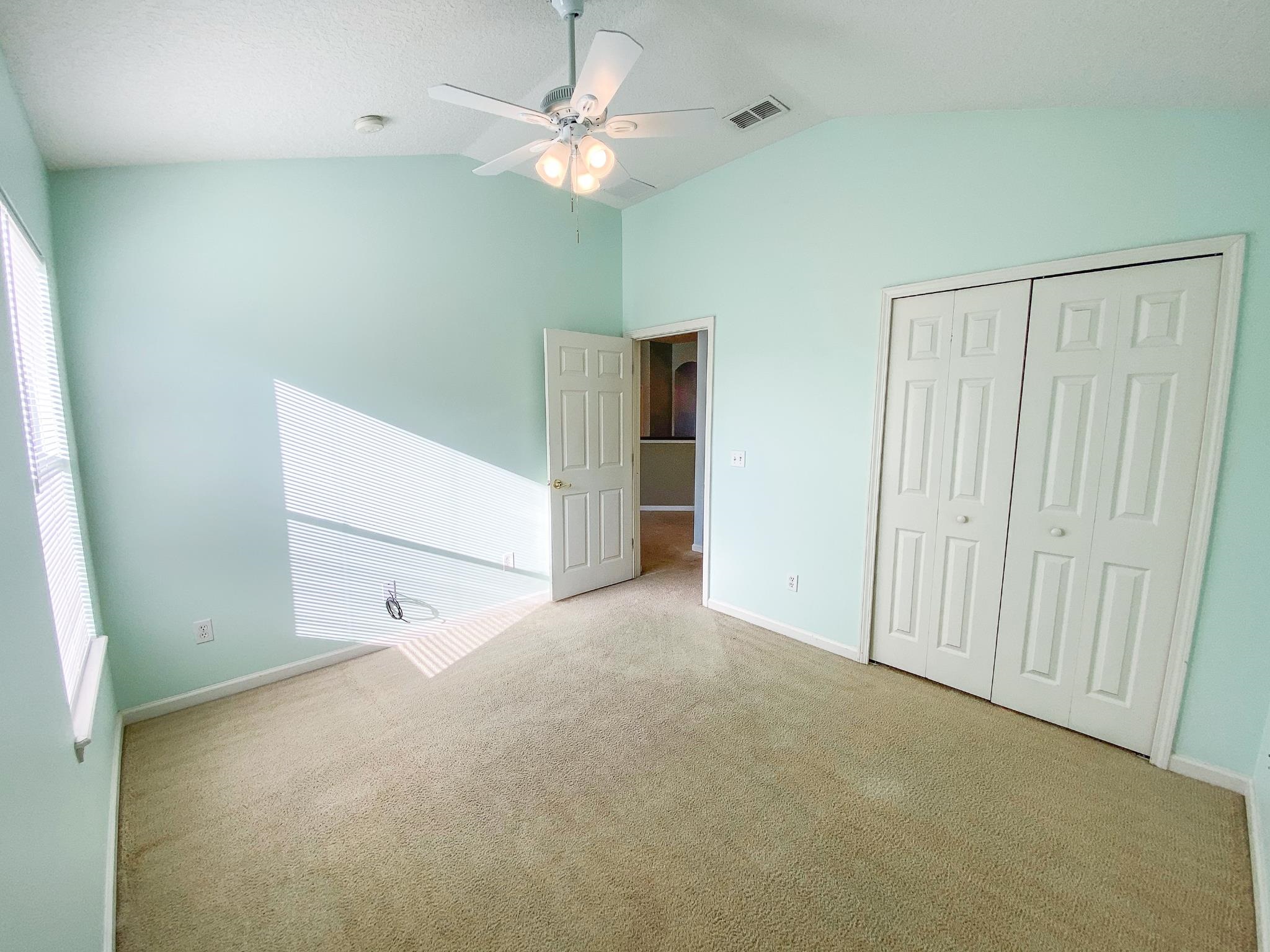 871 East Red House Branch Road St. Augustine, FL 32084 - Photo 17 of 23 an empty room with a ceiling fan and a window
