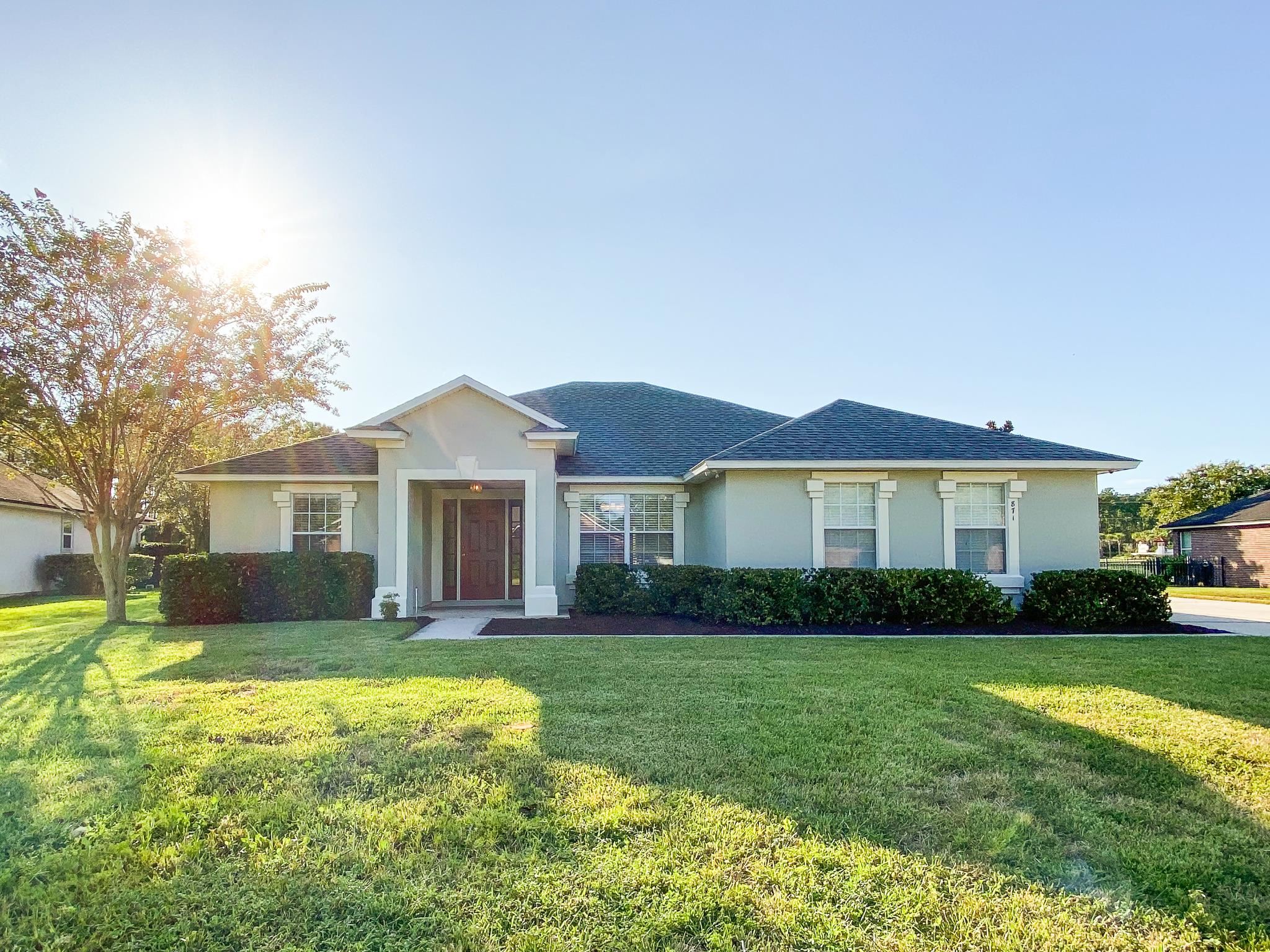871 East Red House Branch Road St. Augustine, FL 32084 - Photo 5 of 23 a view of a house with a big yard and large trees
