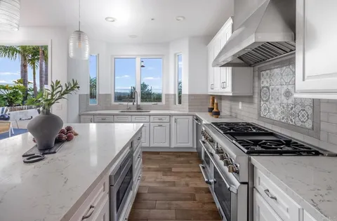a kitchen with a sink stove and cabinets