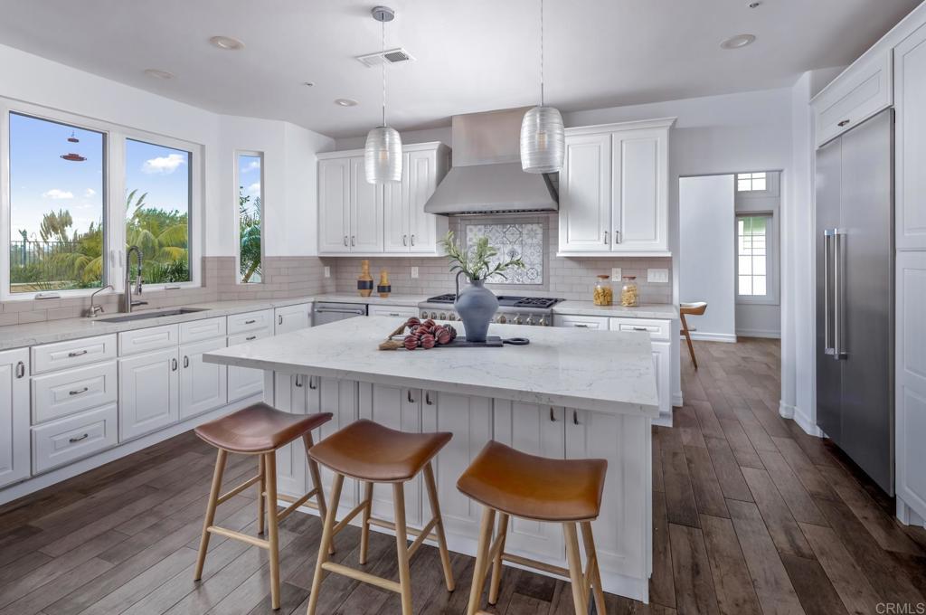 608 Crest Drive Encinitas, CA 92024 - Photo 13 of 32 a kitchen with a sink window and cabinets