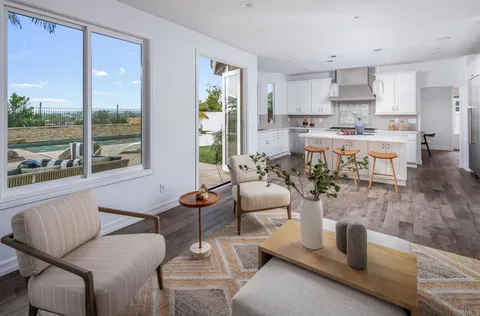 a dining room with furniture and a window