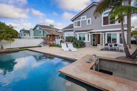 a swimming pool with outdoor seating and yard