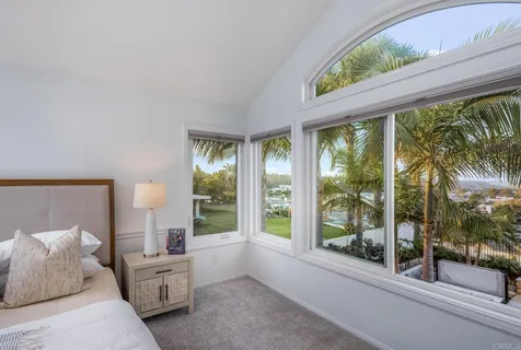a bedroom with furniture and large windows