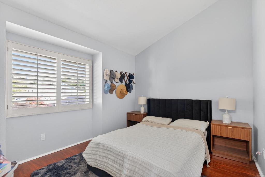 8927 Windham Court Spring Valley, CA 91977 - Photo 12 of 28 a bedroom with a bed and wooden floor