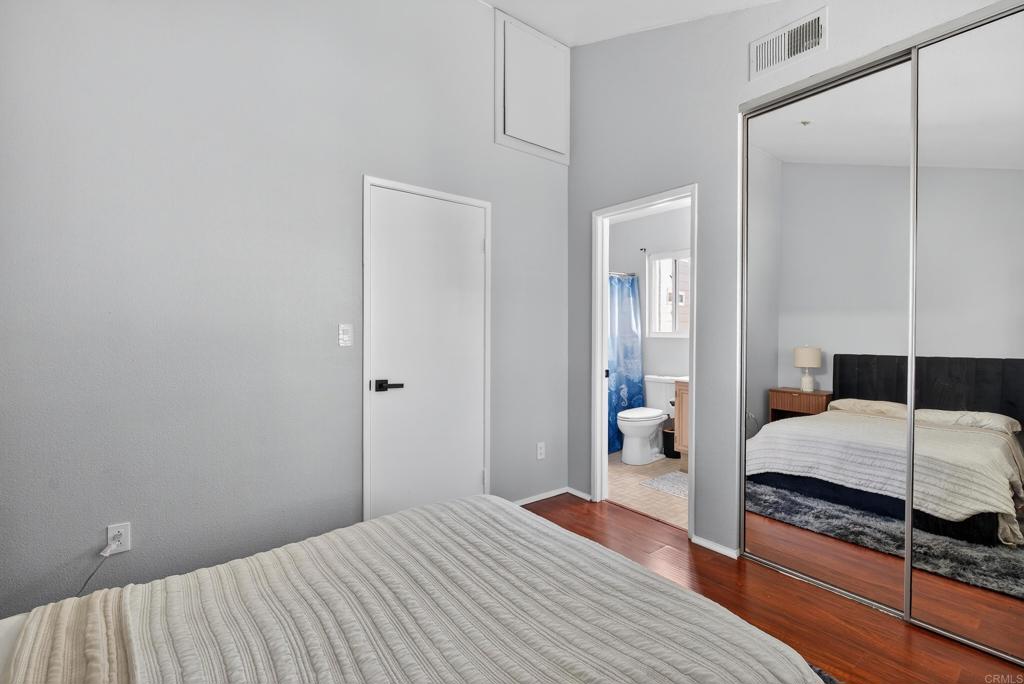8927 Windham Court Spring Valley, CA 91977 - Photo 13 of 28 a bedroom with a bed and wooden floor