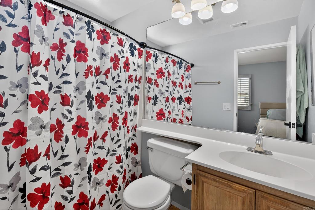 8927 Windham Court Spring Valley, CA 91977 - Photo 15 of 28 a bathroom with a sink and mirror with toilet