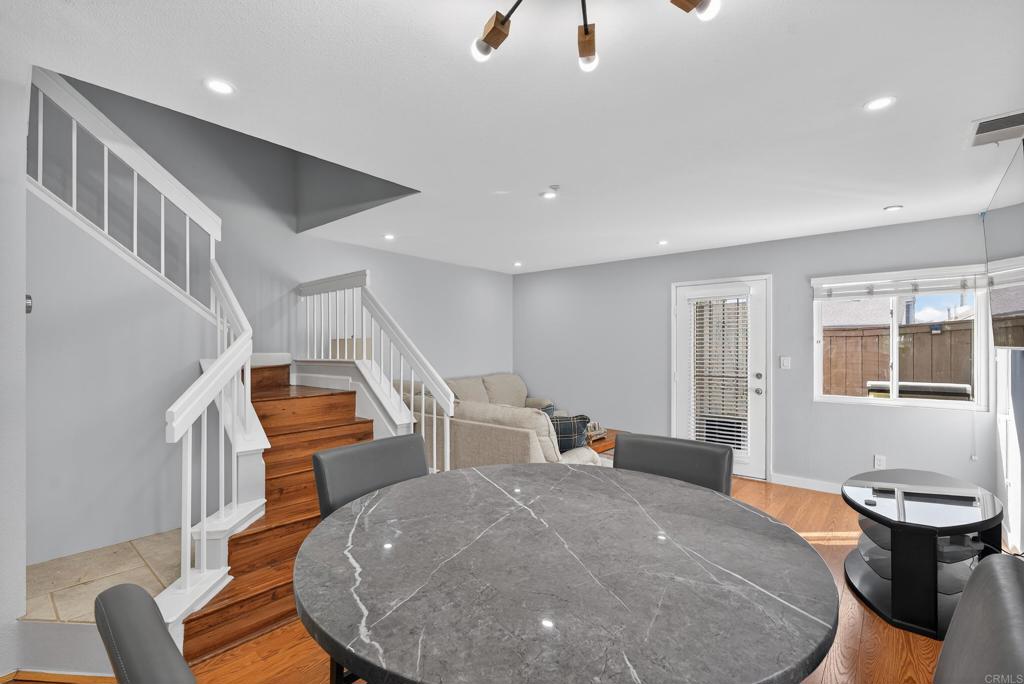 8927 Windham Court Spring Valley, CA 91977 - Photo 2 of 28 a living room with couches and kitchen view with wooden floor