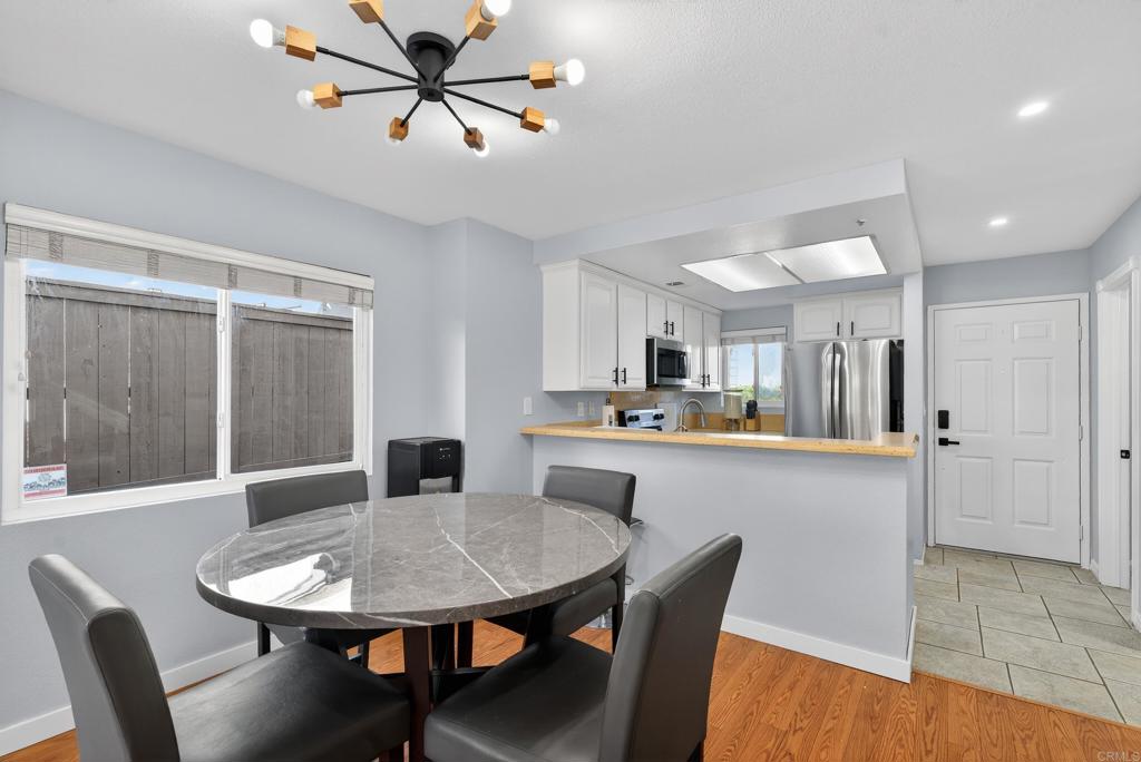 8927 Windham Court Spring Valley, CA 91977 - Photo 3 of 28 a view of a dining room with furniture and wooden floor