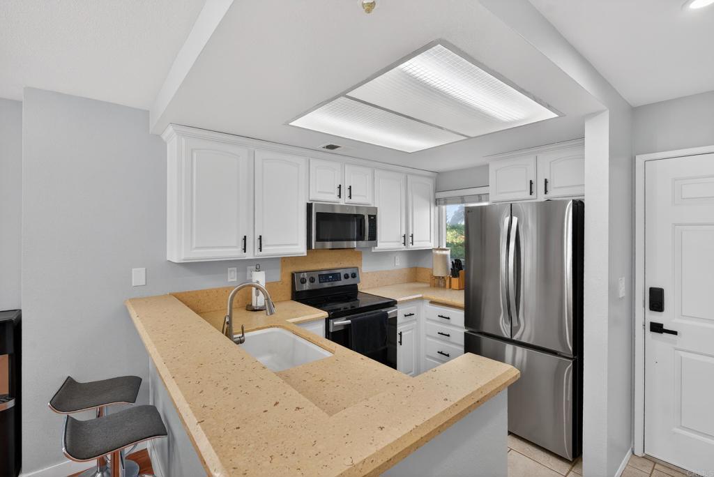 8927 Windham Court Spring Valley, CA 91977 - Photo 5 of 28 a kitchen with stainless steel appliances granite countertop a refrigerator stove microwave and sink