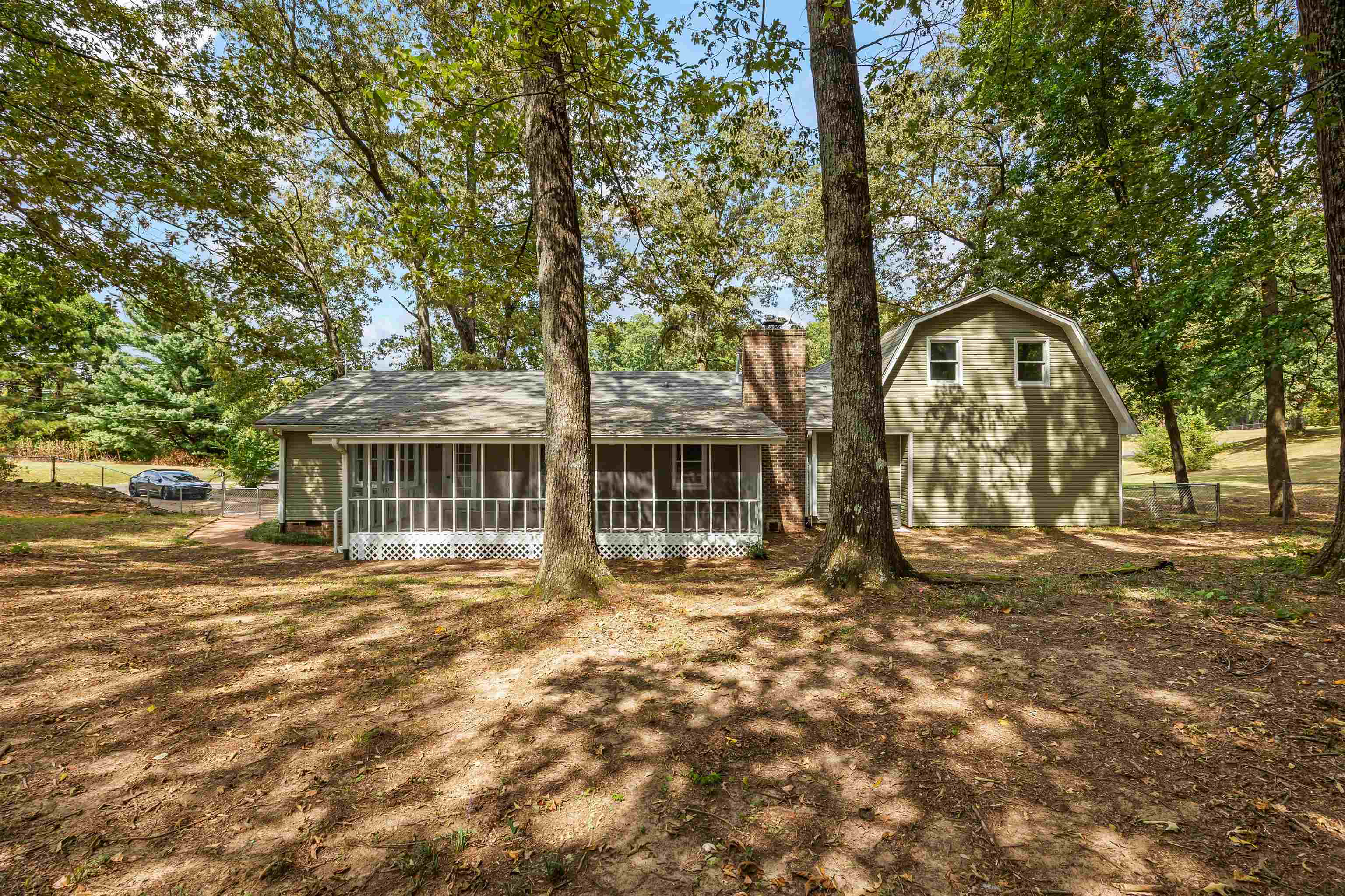 80 Pinewood Drive Jackson, TN 38305 - Photo 9 of 27 Back of house featuring a sunroom, a chimney, and a gambrel roof