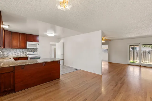 a kitchen with wooden floors and wooden cabinets