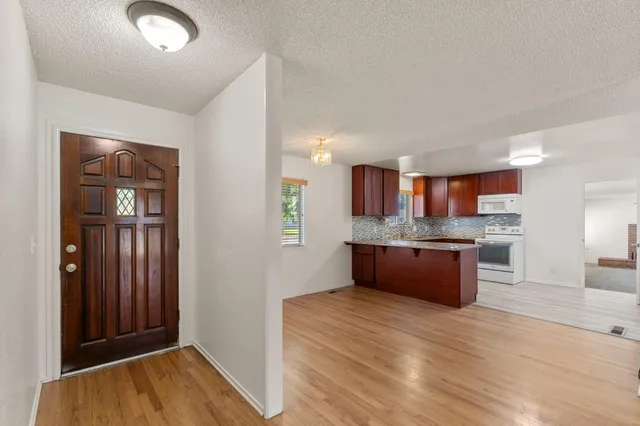 a view of kitchen and wooden floor
