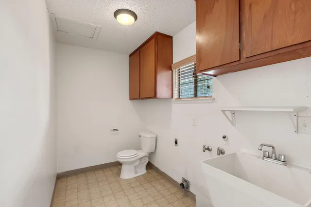 a bathroom with a toilet sink and mirror