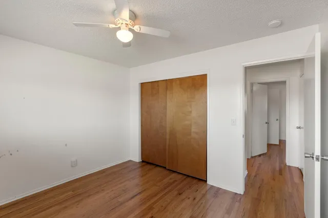 a view of empty room with wooden floor