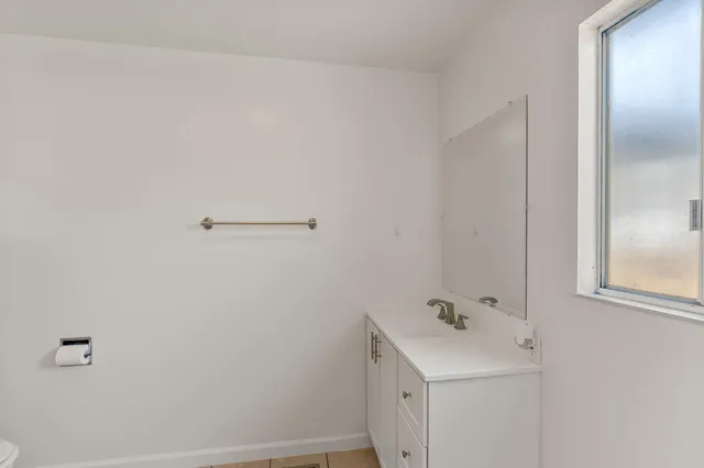 a bathroom with a sink and mirror