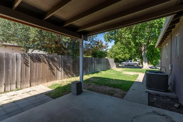 a view of a porch with furniture and a yard