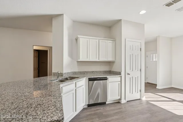 a kitchen with white cabinets
