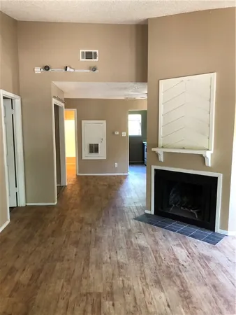 a view of a hallway with fireplace and a window