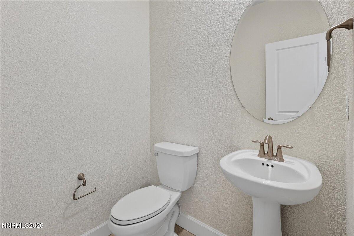 1280 Harness Drive Sparks, NV 89436 - Photo 16 of 46 a bathroom with a sink a toilet and a mirror