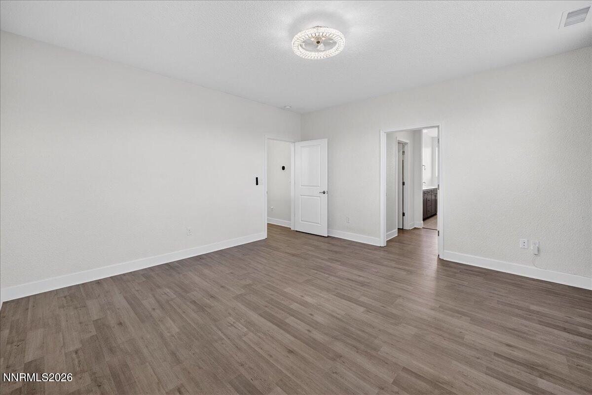 1280 Harness Drive Sparks, NV 89436 - Photo 22 of 46 a view of an empty room with wooden floor