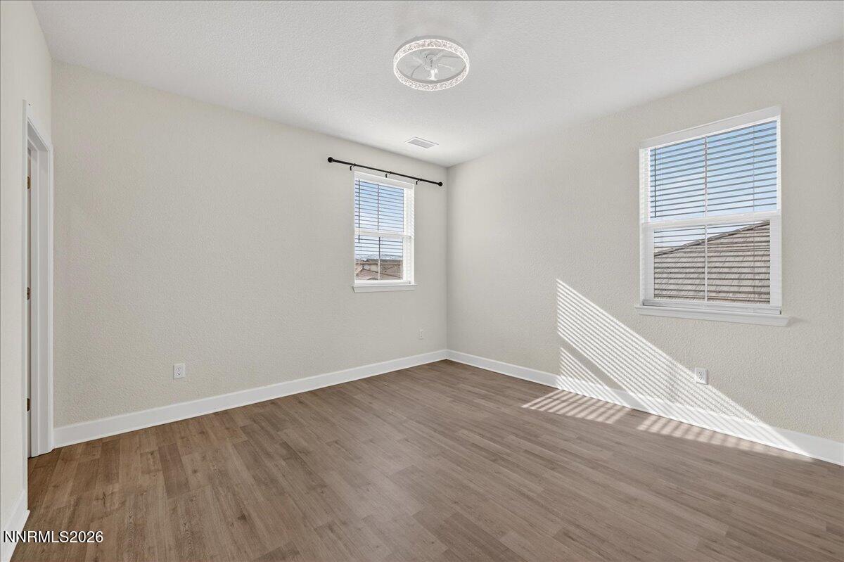 1280 Harness Drive Sparks, NV 89436 - Photo 32 of 46 an empty room with wooden floor and windows