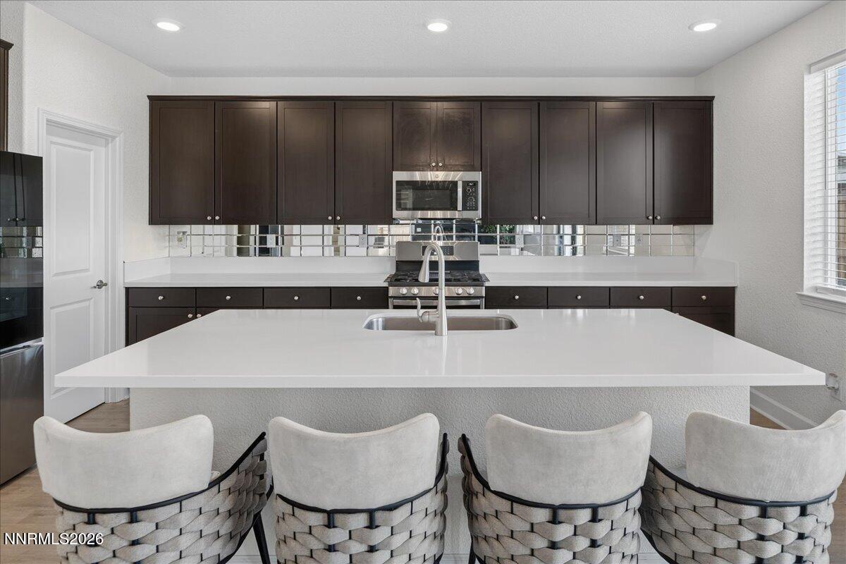 1280 Harness Drive Sparks, NV 89436 - Photo 10 of 46 a kitchen with a kitchen island a sink and a stove