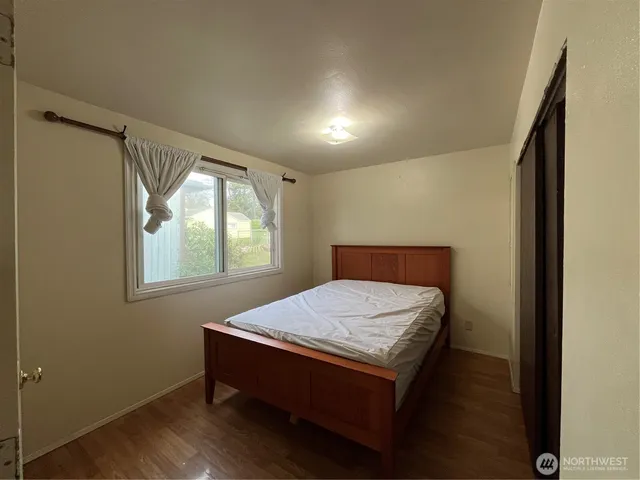 a room with a bed and window