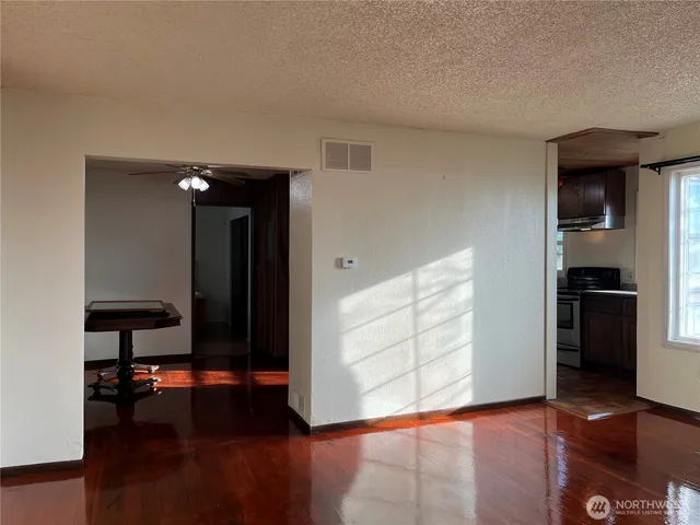 a view of a livingroom with furniture and an empty room