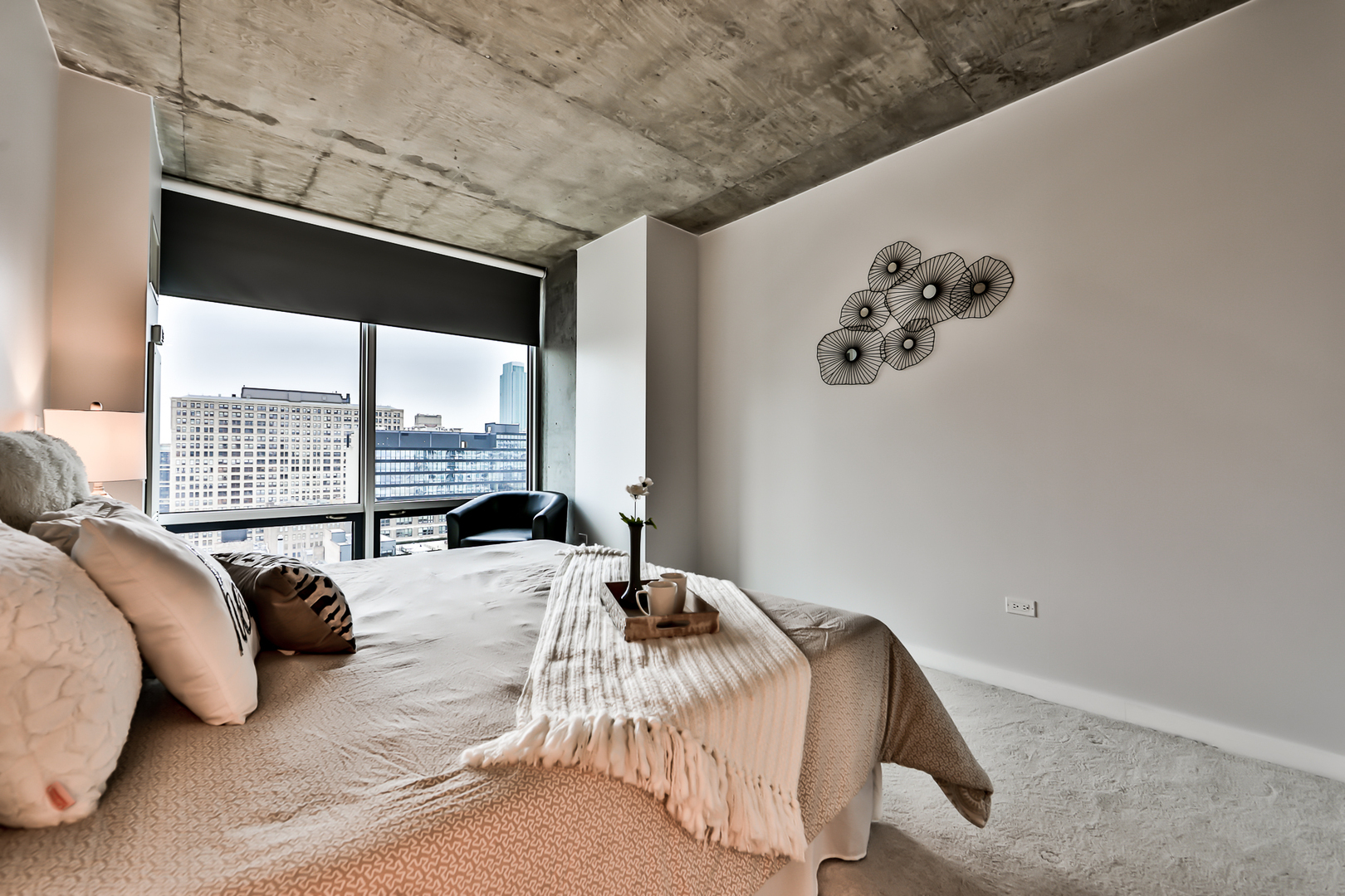 611 South Wells Street, Unit 1903 Chicago, IL 60607 - Photo 13 of 28 a bed sitting in a bedroom next to a window