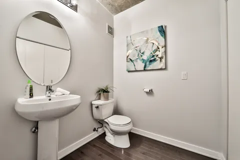 a bathroom with a toilet a sink and a mirror