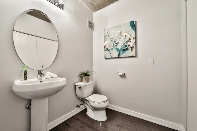 a bathroom with a toilet a sink and a mirror