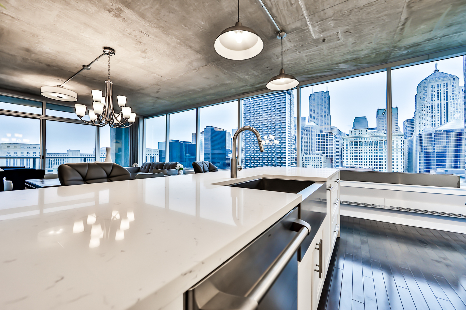 611 South Wells Street, Unit 1903 Chicago, IL 60607 - Photo 5 of 28 a large kitchen with a chandelier
