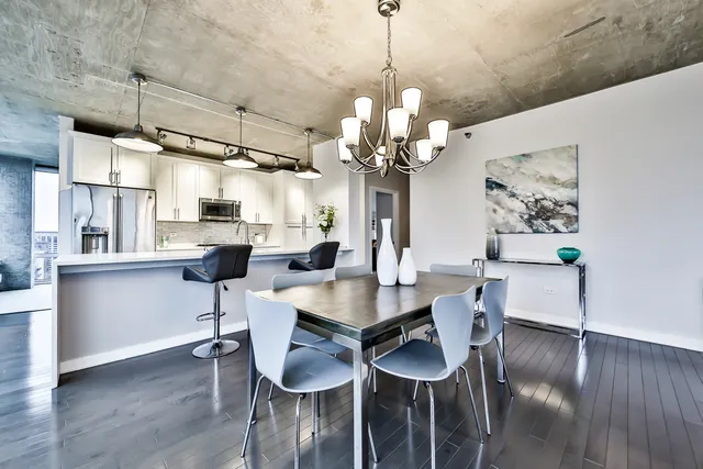 a view of a dining room with furniture wooden floor and chandelier