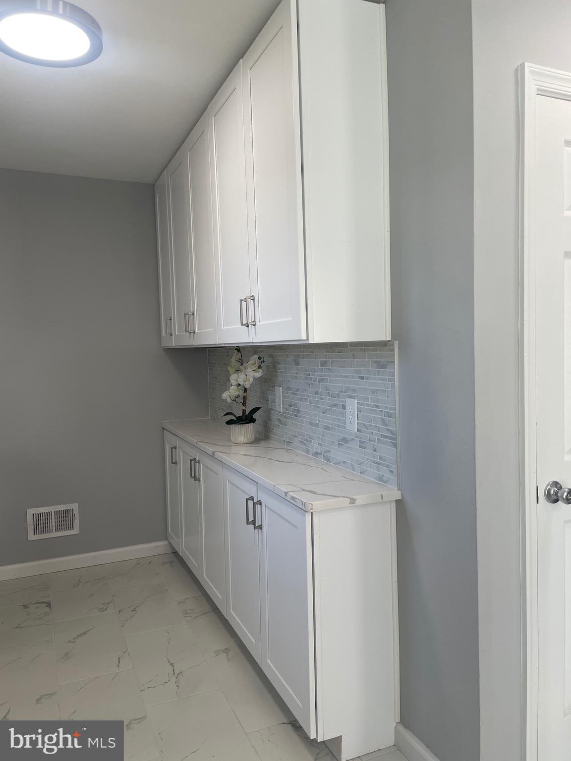 6107 Buckler Road Clinton, MD 20735 - Photo 7 of 45 a view of a kitchen with white cabinets