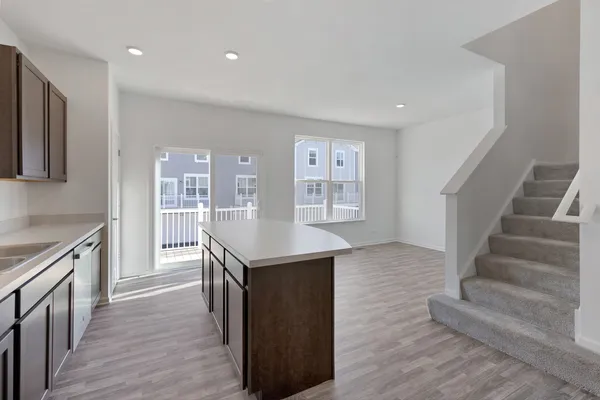 a kitchen with granite countertop a stove and a wooden floors