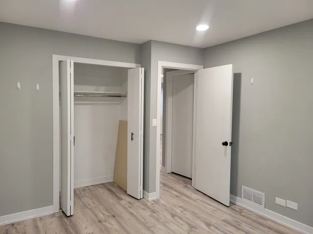 a view of hallway with wooden floor