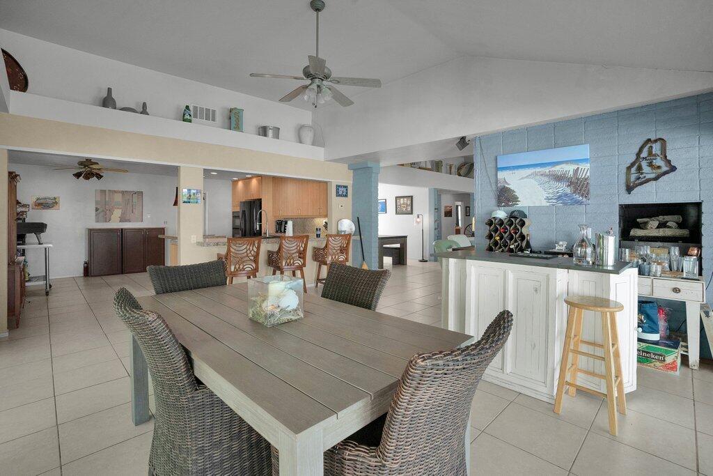 43761 Port Maria Road Bermuda Dunes, CA 92203 - Photo 17 of 50 a dining room with wooden floor a chandelier a wooden table and chairs
