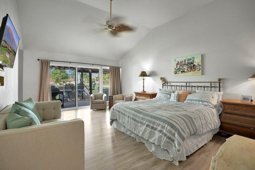 43761 Port Maria Road Bermuda Dunes, CA 92203 - Photo 26 of 50 a spacious bedroom with a bed a couch and a window