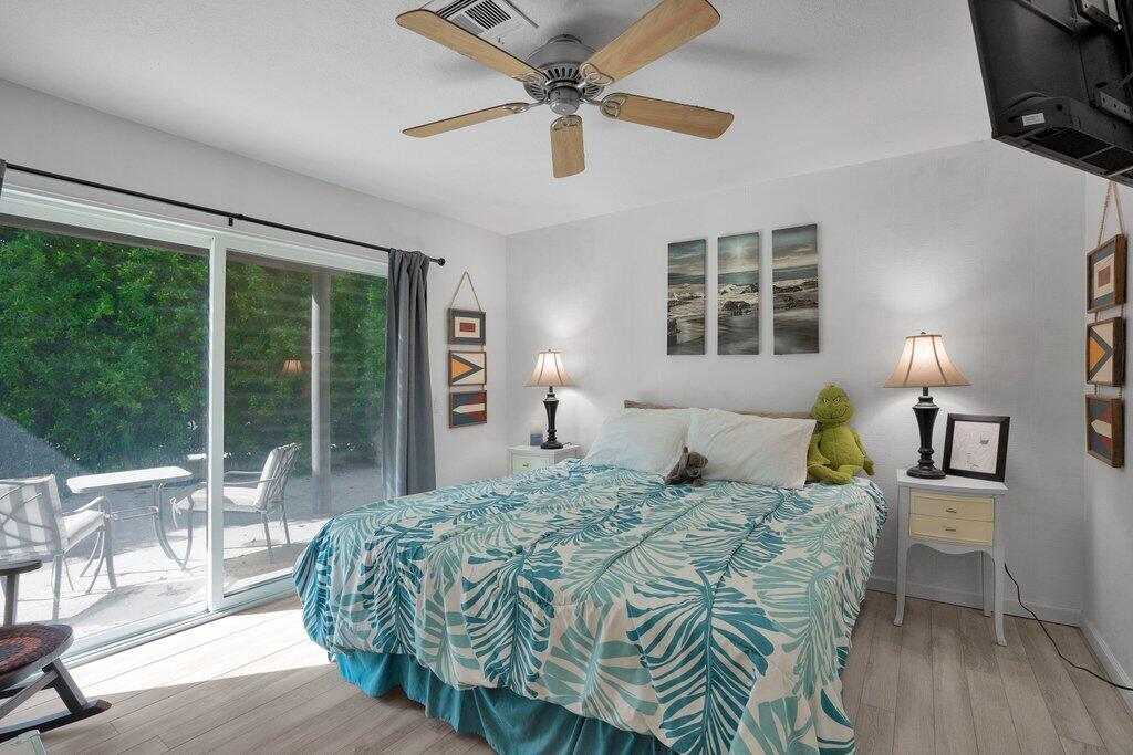 43761 Port Maria Road Bermuda Dunes, CA 92203 - Photo 31 of 50 a bedroom with a bed a ceiling fan and a large window