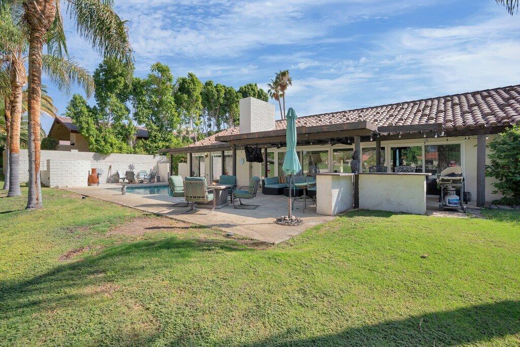 43761 Port Maria Road Bermuda Dunes, CA 92203 - Photo 36 of 50 a view of a patio with table and chairs potted plants and large tree