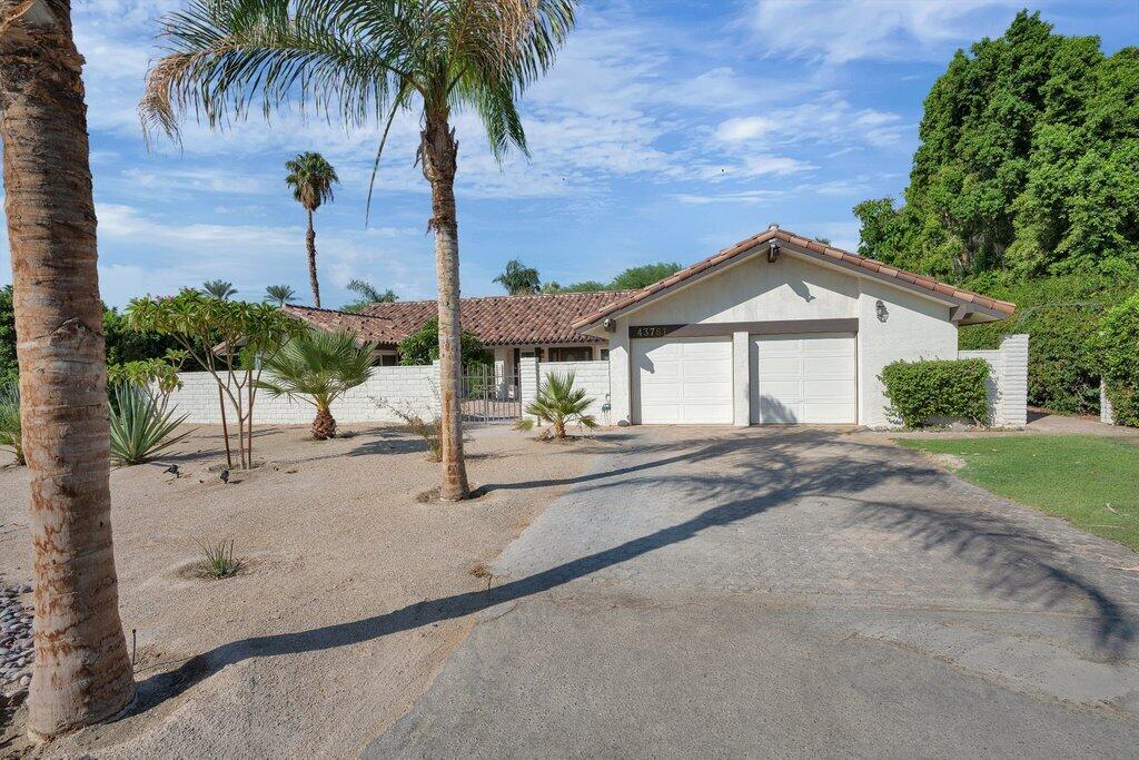 43761 Port Maria Road Bermuda Dunes, CA 92203 - Photo 48 of 50 a view of a house with a yard and potted plants