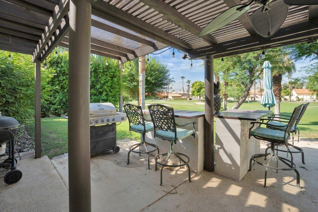 43761 Port Maria Road Bermuda Dunes, CA 92203 - Photo 5 of 50 a view of a chairs and table in patio with a backyard