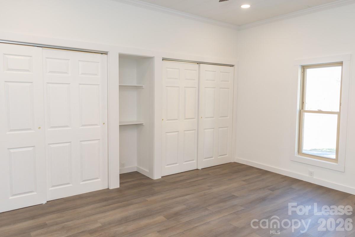 2375 Conley Road Morganton, NC 28655 - Photo 13 of 15 an empty room with wooden floor and cabinet