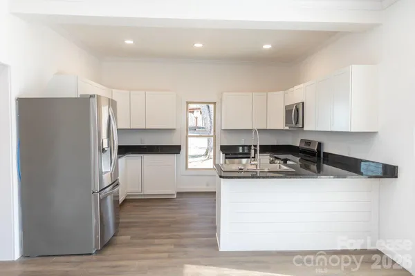 a kitchen with a refrigerator and a sink