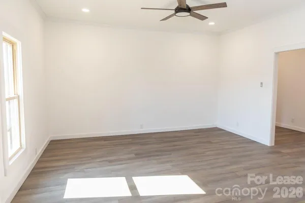 a view of a room with wooden floor and a window