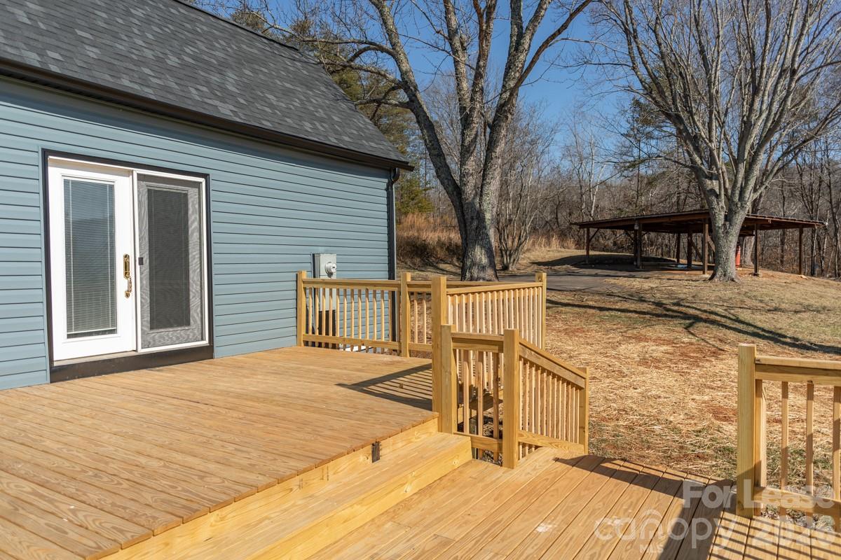 2375 Conley Road Morganton, NC 28655 - Photo 8 of 15 a backyard of a house with wooden fence and large trees